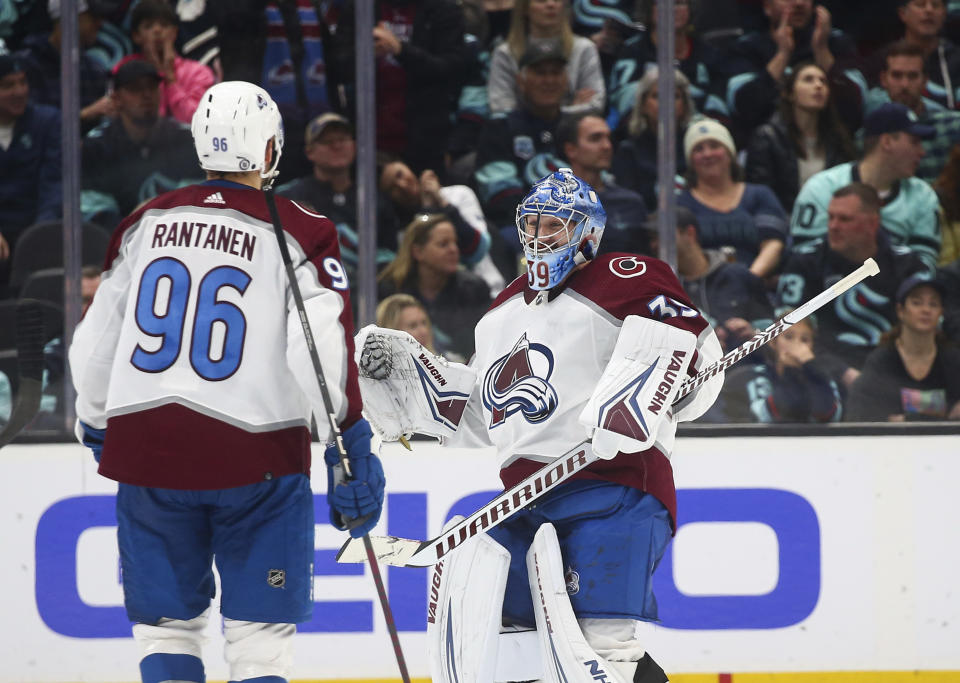 Colorado Avalanche goaltender Pavel Francouz (39) greets right wing Mikko Rantanen (96) after the team's shootout win over Seattle Kraken in an NHL hockey game Saturday, Jan. 21, 2023, in Seattle. The Avalanche won 2-1. (AP Photo/Lindsey Wasson)