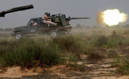 Libyan forces allied with the U.N.-backed government fire weapons during a battle with Islamic State fighters in Sirte. REUTERS/Goran Tomasevic