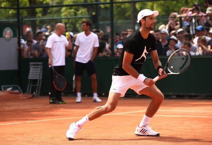 Novak Djokovic practices on the first day of the French Open while coach Andre Agassi watches on from behind (Getty Images). 