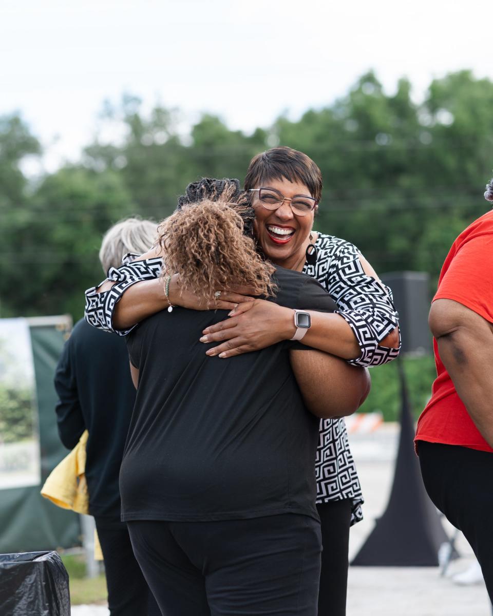 Dr. Linda Cowels, CEO of Anointed Community Services, embraces Mozelle Faniel, in celebration of the empowerment center bearing the name of Faniel's late grandmother, Elese Tomlin.