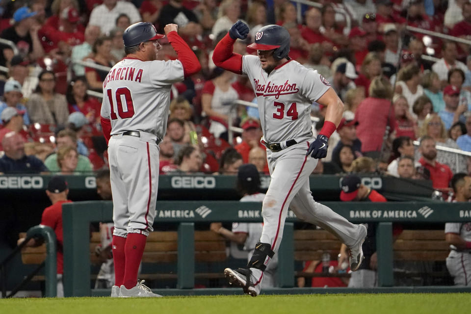 Washington Nationals' Luke Voit (34) is congratulated by third base coach Gary Disarcina after hitting a two-run home run during the eighth inning of a baseball game against the St. Louis Cardinals Wednesday, Sept. 7, 2022, in St. Louis. (AP Photo/Jeff Roberson)