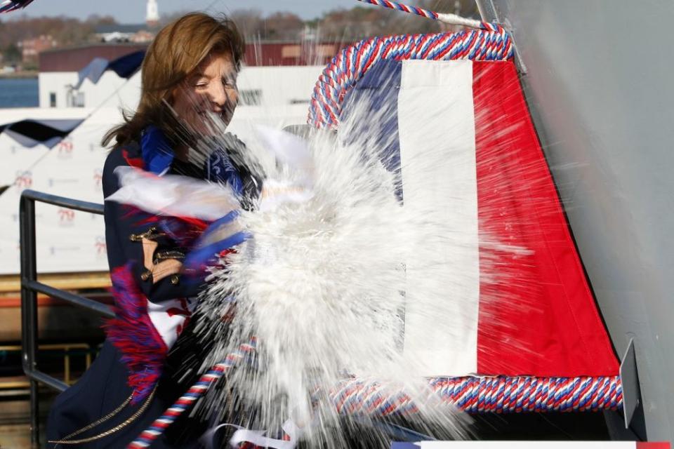 Caroline Kennedy smashes a bottle of sparkling wine on the new John F. Kennedy Navy ship. | Steve Helber/AP/Shutterstock