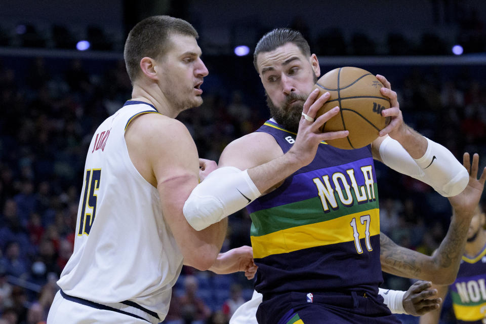 New Orleans Pelicans center Jonas Valanciunas (17) moves around Denver Nuggets center Nikola Jokic (15) during the first half of an NBA basketball game in New Orleans, Tuesday, Jan. 24, 2023. (AP Photo/Matthew Hinton)