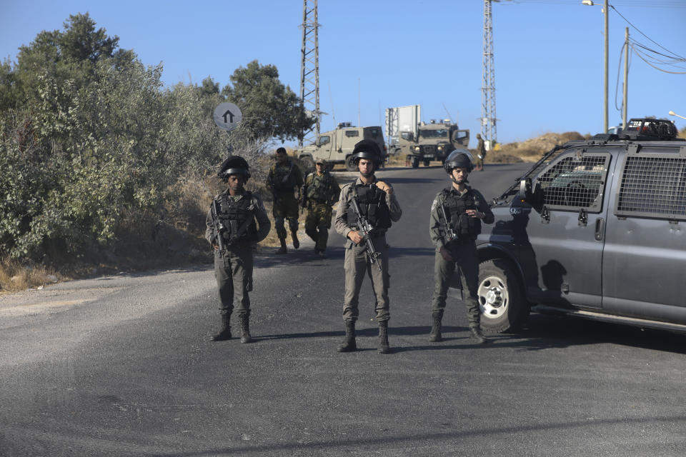Israeli troops secure the area where a body of a soldier with stab wounds was found near Gush Etzion settlement in the West Bank, Thursday, Aug, 8, 2019. (AP Photo/Mahmoud Illean)