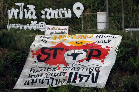 A protest banner demanding to stop rapids blasting at the Mekong River, is seen at the border between Laos and Thailand April 24, 2017. Picture taken April 24, 2017. REUTERS/Jorge Silva