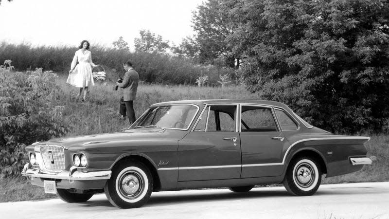 A black and white photo of a Plymouth Valiant. 