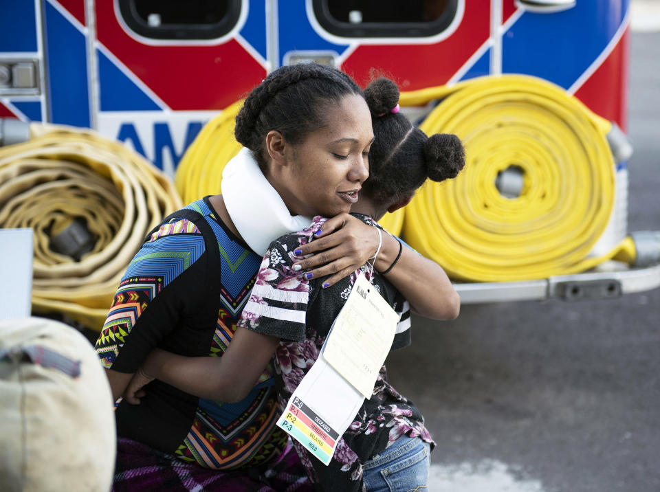 In this Thursday, Aug. 30, 2018 photo, Cynthia Billingsley hugs her daughter Niyomie, 5, after being treated and released from the hospital in Gallup, N.M., hours after the Greyhound bus they were riding in was involved in a collision with a semi-truck on Interstate 40 near Thoreau, N.M. A California-based trucking company and one of its drivers were accused of negligence Friday in a pair of lawsuits as investigators sorted through the wreckage from a deadly bus crash on a New Mexico highway. (Alma E. Hernandez/Gallup Independent via AP)