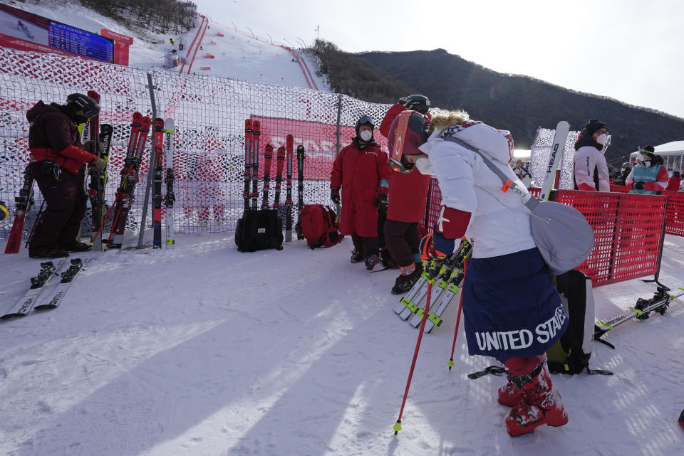 Mikaela Shiffrin of United States stands in the mixed zone near the finish area after skiing off course during the first run of the women's giant slalom at the 2022 Winter Olympics, Monday, Feb. 7, 2022, in the Yanqing district of Beijing. (AP Photo/Luca Bruno)