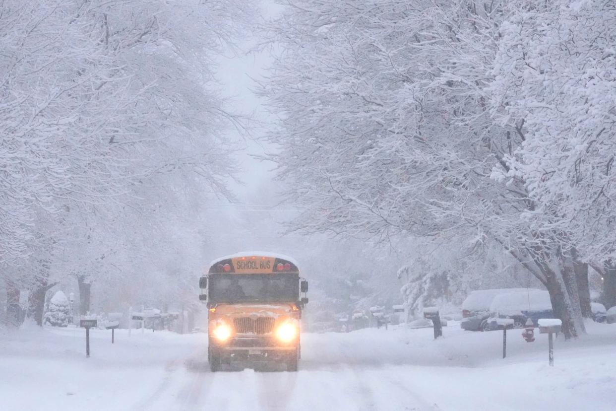 A school bus heads through the snow down North Seneca Road in Glendale on Thursday, Jan. 11, 2024.