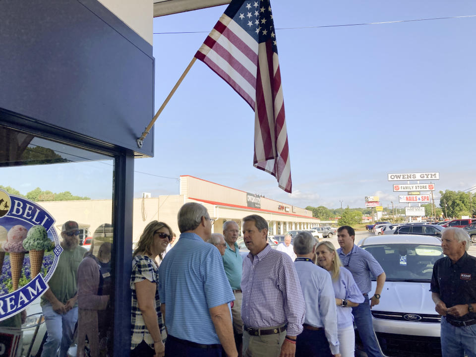 Georgia Gov. Brian Kemp speaks to a supporter before a speech on Thursday, Aug. 4, 2022, in Toccoa, Ga. Republicans in Georgia increasingly rely on voters in north Georgia areas including Toccoa as their margins shrink in suburban Atlanta. (AP Photo/Jeff Amy)