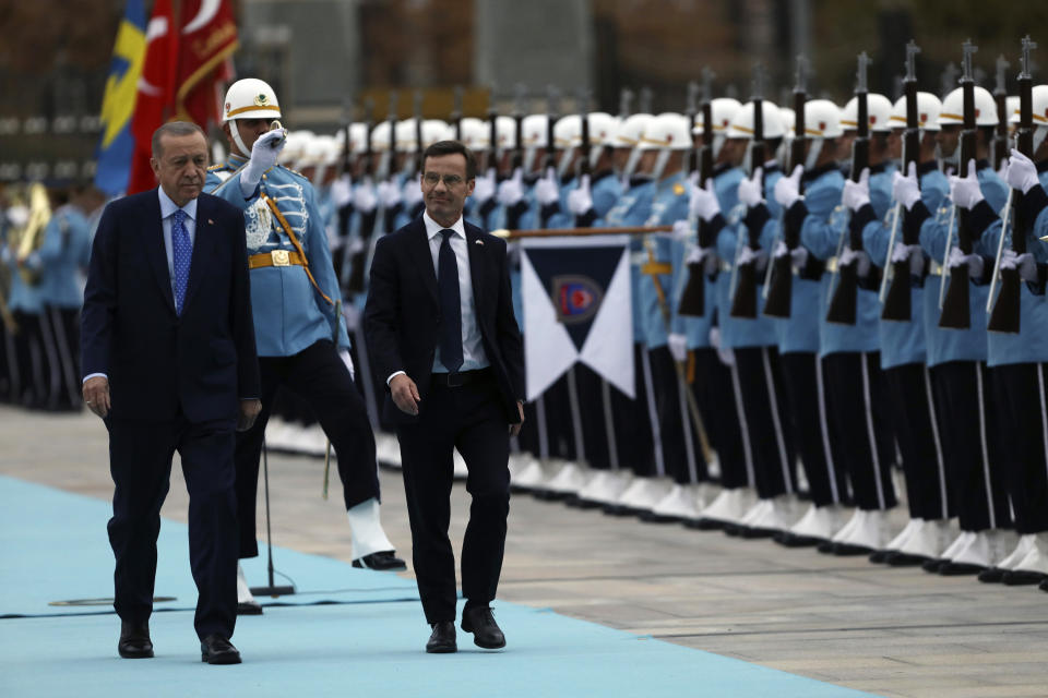 Turkish President Recep Tayyip Erdogan, left, and Sweden's Prime Minister Ulf Kristersson inspect a military honour guard during a welcome ceremony at the presidential palace in Ankara, Turkey, Tuesday, Nov. 8, 2022. Kristersson is meeting Erdogan in an effort to clinch Turkish approval for his country's bid to join NATO. (AP Photo/Burhan Ozbilici)