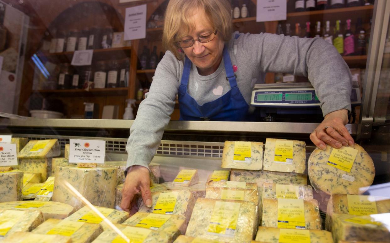 Linda Wood organising Stilton cheese for sale at the Melton Cheeseboard in Melton Mowbray - Andrew Fox 