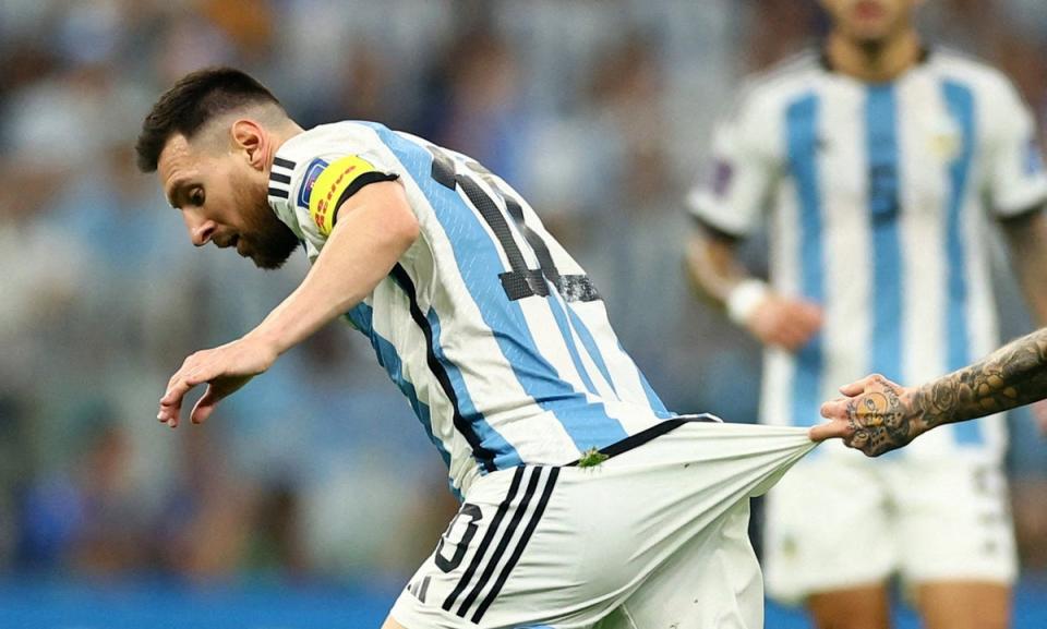 Argentina’s Lionel Messi’s shorts are pulled by Croatia’s Marcelo Brozovic (REUTERS)