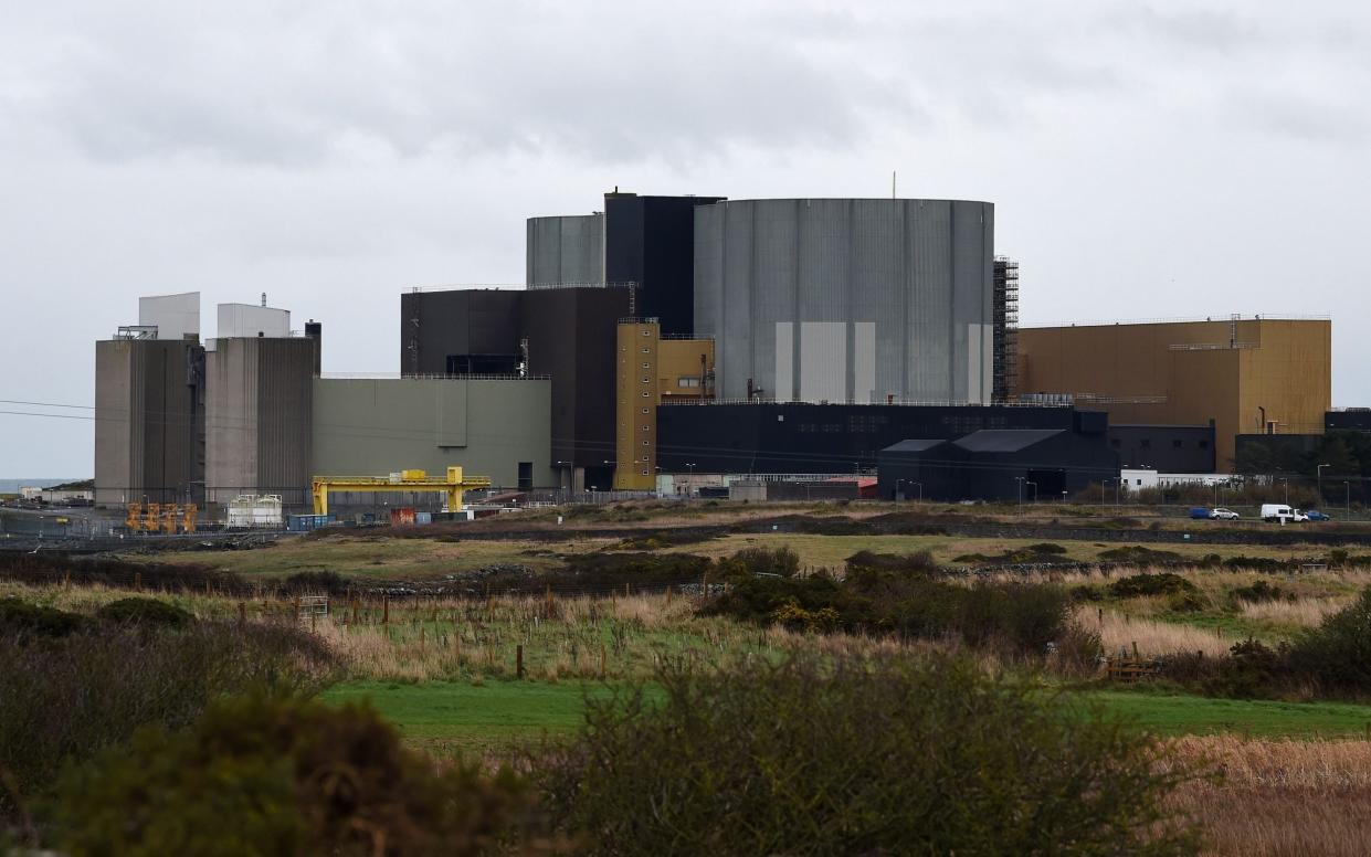  In this file photo taken on January 18, 2019 The Wylfa Newydd nuclear power station is pictured beyond farmer's fields on Anglesey, north-west Wales. - Japan's Hitachi said on August 17, 2020, it was ready to relaunch a nuclear power project in Wales that was put on hold early last year because of wrangling over financing. The company's Horizon Nuclear subsidiary said it was "continuing to engage with the UK government, and others, on securing the right conditions to support a potential restart for Wylfa Newydd" on Anglesey island off northwest Wales. - AFP