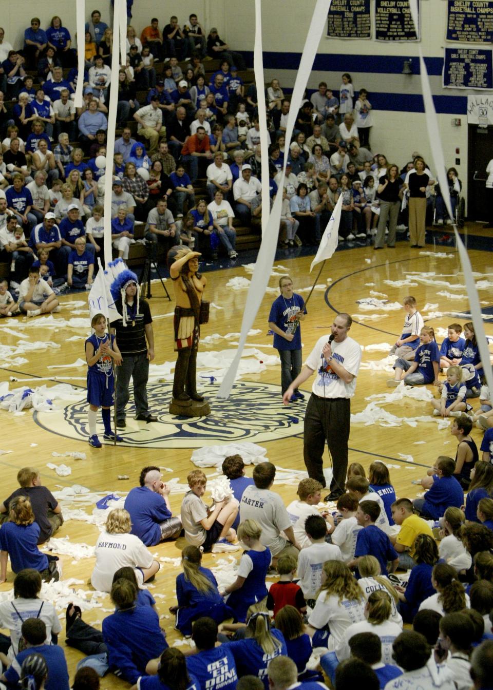 With toilet paper hanging from the rafters, Waldron coach Jason Delaney thanks the fans in the school's gym during a pep rally celebrating the team's 2004 Class A state championship over Fort Wayne Blackhawk Christian.