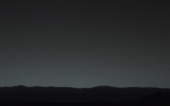 This view of the twilight sky and Martian horizon taken by NASA's Curiosity Mars rover includes Earth as the brightest point of light in the night sky. Earth is a little left of center in the image, and our moon is just below Earth. The Curiosi