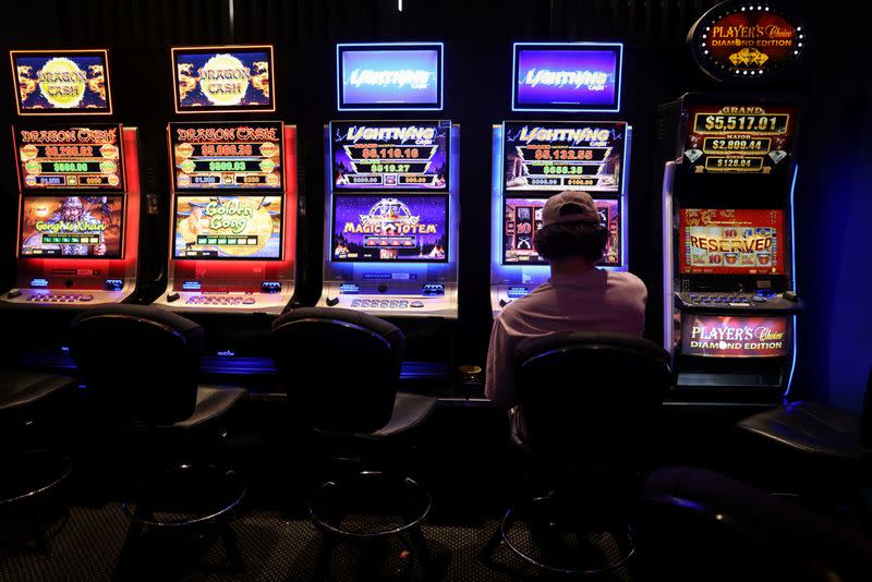 A person gambles on a poker machine at a pub in Sydney