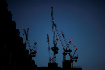 FILE PHOTO: Construction cranes are seen on a building site at sunrise in central London, Britain May 19, 2018. REUTERS/Benoit Tessier/File Photo