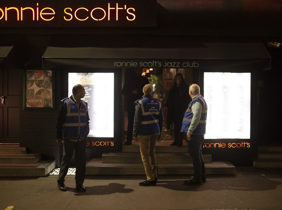 A photo of Ronnie Scott's Jazz Club staff reassuring London's city inspectors they were abiding by new coronavirus rules.