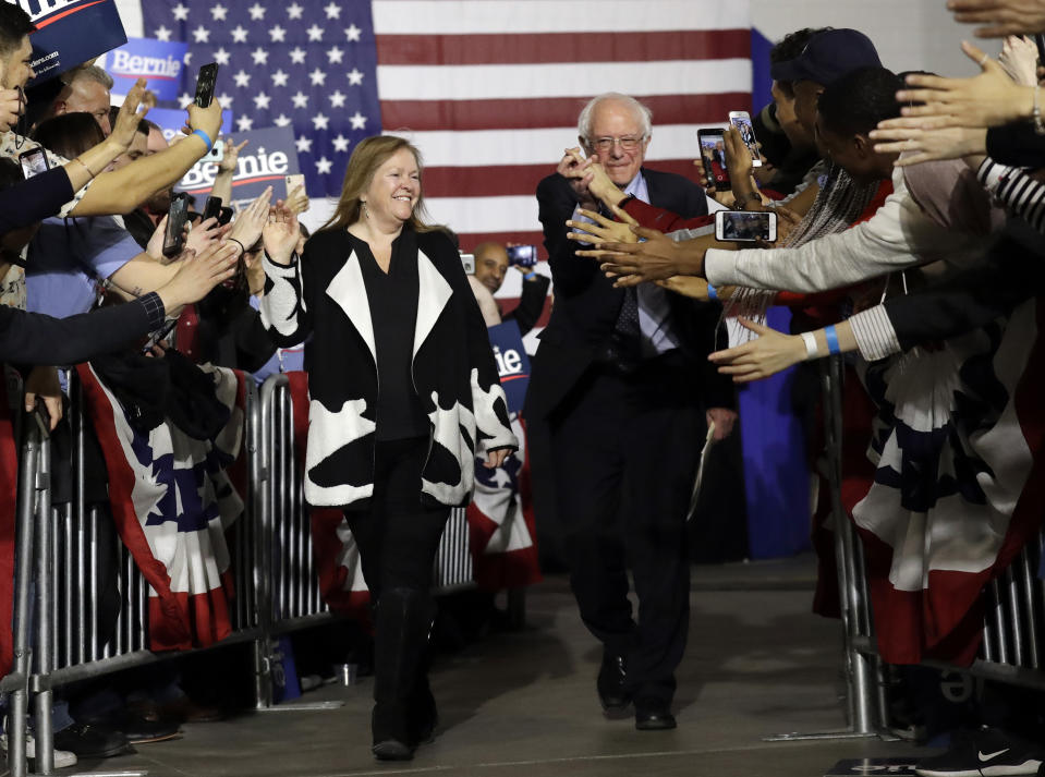 FILE - In this March 3, 2019, file photo, Sen. Bernie Sanders, I-Vt., right, and his wife Jane Sanders, greet supporters as they arrive arrive for a campaign event at Navy Pier in Chicago. Bernie Sanders’ revolution is Jane Sanders’ career. And her political and business activities have at times been his headache. His closest adviser, she is perhaps the most influential woman in the 2020 campaign who isn’t a candidate. (AP Photo/Nam Y. Huh, File)