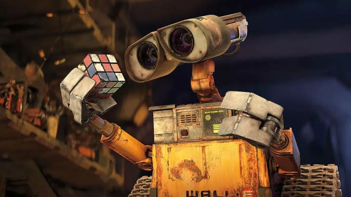 The title character in Wall-E holding a rubiks cube.
