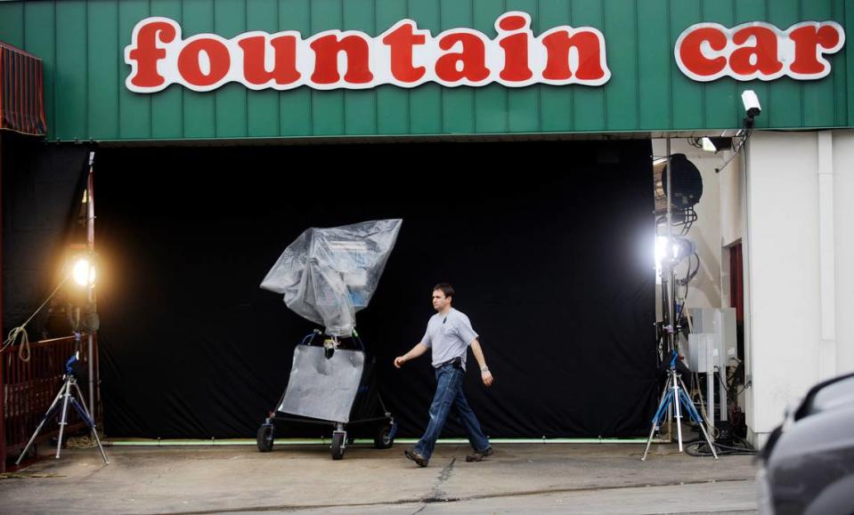 In this Telegraph file photo, a crew member heads out of the closed set at Fountain Car Wash on busy Hardeman Avenue where a Hollywood production company is making “The Crazies.”