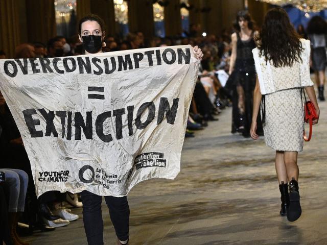 Protestor on Louis Vuitton SS22 Runway Show