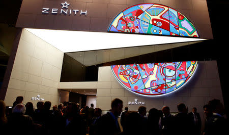 Visitors walk past the exhibition stand of Swiss watch manufacturer Zenith at the Baselworld Watch and Jewellery Show in Basel, Switzerland March 23, 2017. REUTERS/Arnd Wiegmann
