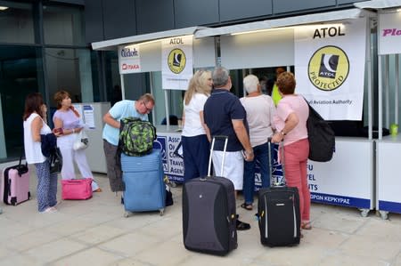 Passengers line up in front of a counter of ATOL, at the Ioannis Kapodistrias Airport after Thomas Cook, the world's oldest travel firm collapsed