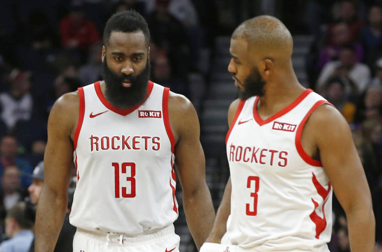 Houston Rockets' James Harden, left, and Chris Paul confer in an NBA basketball game against the Minnesota Timberwolves Wednesday, Feb. 13, 2019, in Minneapolis. (AP Photo/Jim Mone)