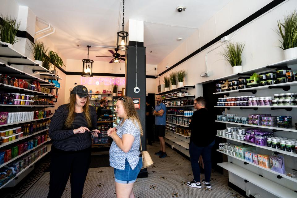 Employees talk with customers at the Despensary, 221 4th St., on Friday, September 29, 2023 in Des Moines.