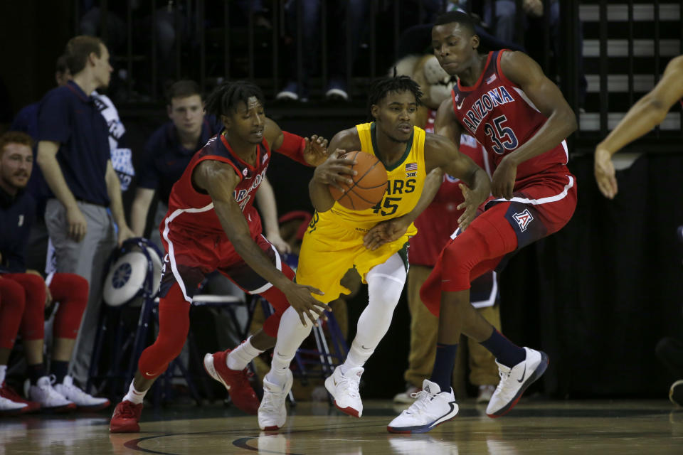 Baylor guard Davion Mitchell (45) tries to get past Arizona guard Dylan Smith (3) and Arizona center Christian Koloko (35) during the first half of an NCAA college basketball game in Waco, Texas, Saturday, Dec. 7, 2019. (AP Photo/Michael Ainsworth)