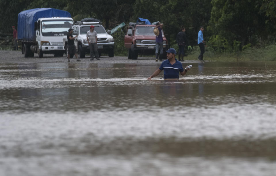 A man walks through a flooded road in Okonwas, Nicaragua, Wednesday, Nov. 4, 2020. Eta weakened from the Category 4 hurricane to a tropical storm after lashing Nicaragua's Caribbean coast for much of Tuesday, its floodwaters isolating already remote communities and setting off deadly landslides. (AP Photo/Carlos Herrera)