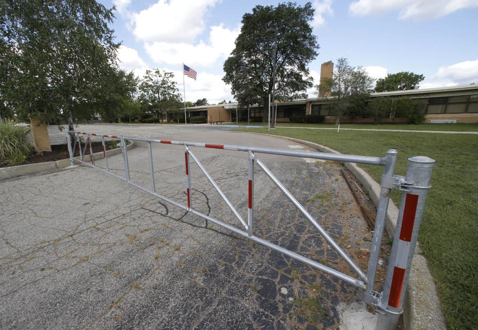 A gate is shown outside the former Eagle Elementary School in West Bloomfield, Mich., Wednesday, Aug. 29, 2012. This affluent Detroit suburb with a diverse mix of religions and races and center of the region's Jewish community is the latest battleground over mosque construction, as some residents push back against a school district's decision to sell a vacant elementary school to an Islamic group. The Farmington Hills school district defends its agreement to sell Eagle Elementary School to a Muslim association and an administrator says opposition now can be classified as "Islamophobia." (AP Photo/Paul Sancya)