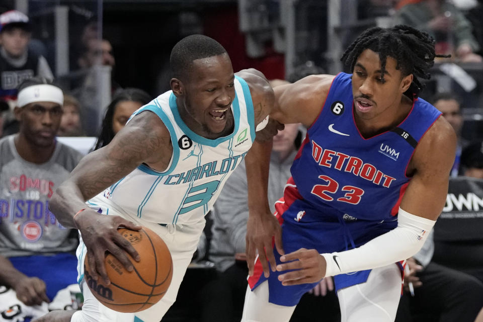 Charlotte Hornets guard Terry Rozier (3) takes the ball up court as Detroit Pistons guard Jaden Ivey (23) defends during the first half of an NBA basketball game, Thursday, March 9, 2023, in Detroit. (AP Photo/Carlos Osorio)