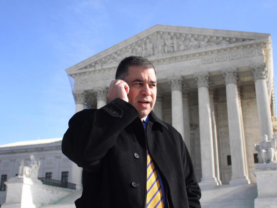 Citizens United President David Bossie talks on his cell phone outside the Supreme Court in Washington