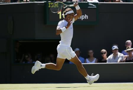 Rafael Nadal of Spain hits a shot during his match against Thomaz Bellucci of Brazil at the Wimbledon Tennis Championships in London, June 30, 2015. REUTERS/Stefan Wermuth