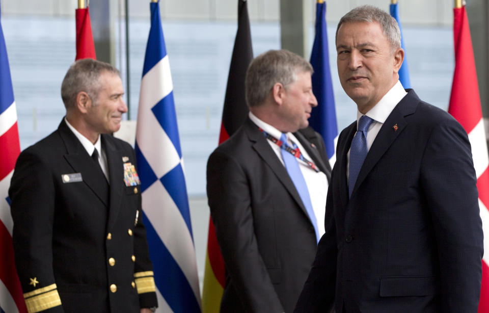 Turkish Defense Minister Hulusi Akar, right, arrives for a meeting of NATO defense ministers at NATO headquarters in Brussels, Wednesday, June 26, 2019. (AP Photo/Virginia Mayo, Pool)