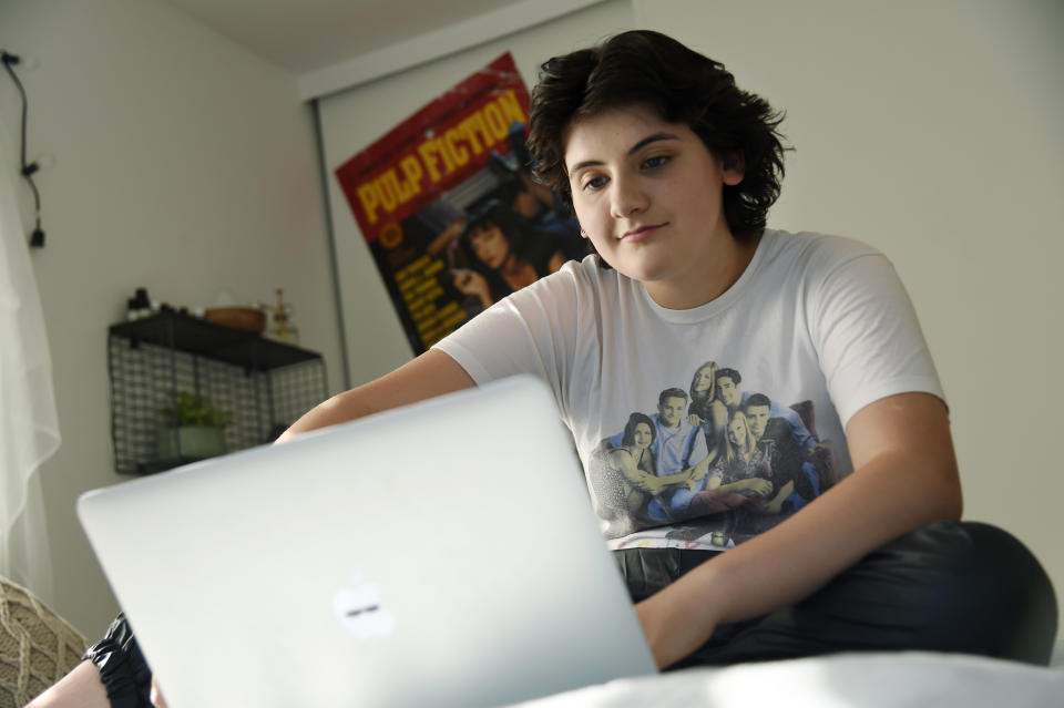 In this Thursday, Aug. 22, 2019 photo, Esme Goldman, 13, streams an episode of the '90s sitcom "Friends" via Netflix on her laptop in her bedroom, in Pasadena, Calif. “Friends” marks its 25th anniversary Sunday, Sept. 22 and the quintessential 1990s sitcom has attracted a new slew of viewers who are barely half that age. Tween and teen girls in particular have embraced the show with huge enthusiasm, taking a show that belonged to Generation X and making it their own. (Photo by Chris Pizzello/Invision/AP)