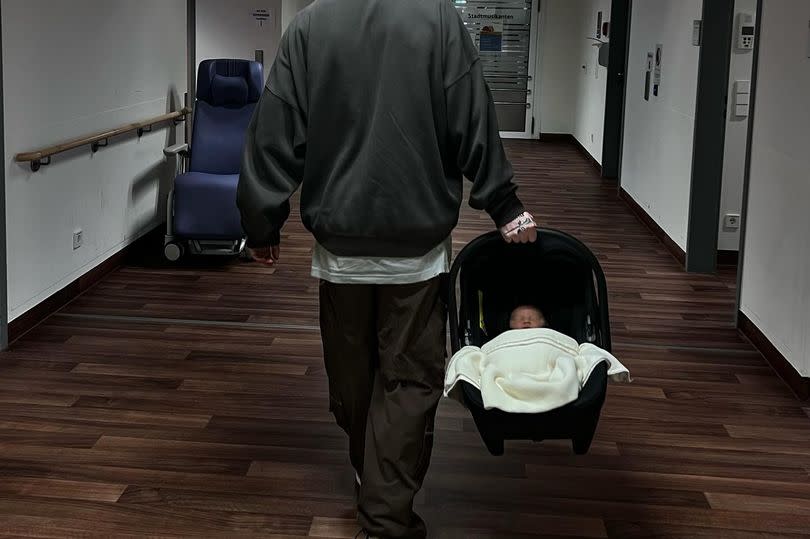 Megan also posted a snap of her partner Oliver carrying his son out of hospital