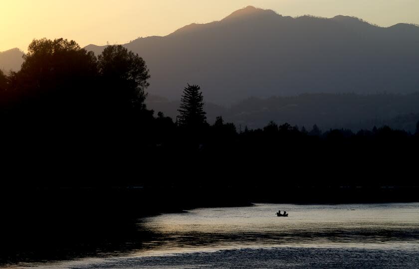 REDDING, CA - OCT. 24, 2020. Fishermen ply the waters of the Sacramento River in Redding on Saturday, Oct. 24, 2020. Redding is a conservative stronghold and home to the Bethel Church and its affiliated School of Supernatural Ministry. Members of the church and school have fueled a major coronavirus outbreak in Redding, with nearly 300 cases reported, Critics blame the church for Shasta County falling back to a more restrictive state tier. One church leader said masks don't work against spreading the virus. Bethel weilds infuence in the city, where members make up 10% of the population. (Luis Sinco / Los Angeles Times)