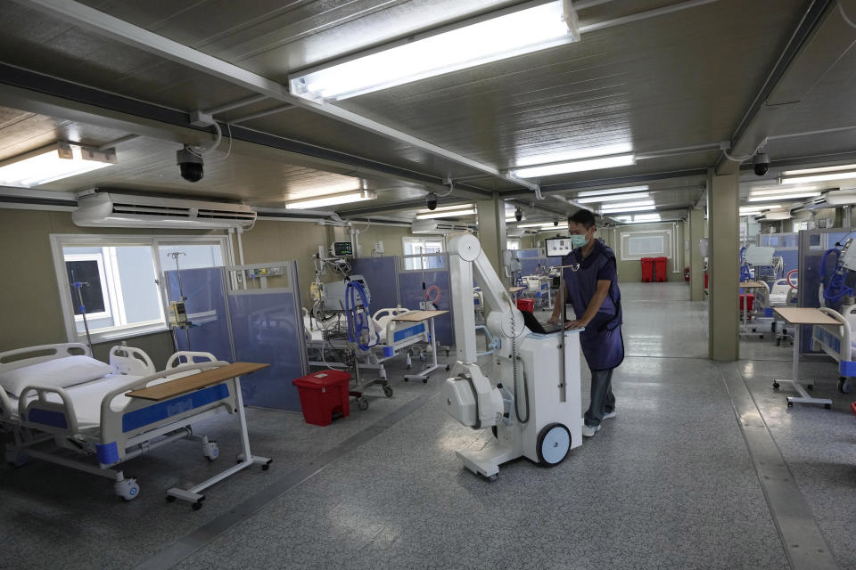 Health workers add a mobile x-ray machine at field hospital for COVID-19 patients at the 11th Army Region base in Bangkok, Thailand, Friday, July 2, 2021. As Thailand faces growing numbers of COVID-19 cases and related deaths during a devastating third wave of the coronavirus, there are concerns that it will face a shortage of hospital beds, intensive care units and ventilators for seriously ill patients. (AP Photo/Sakchai Lalit)