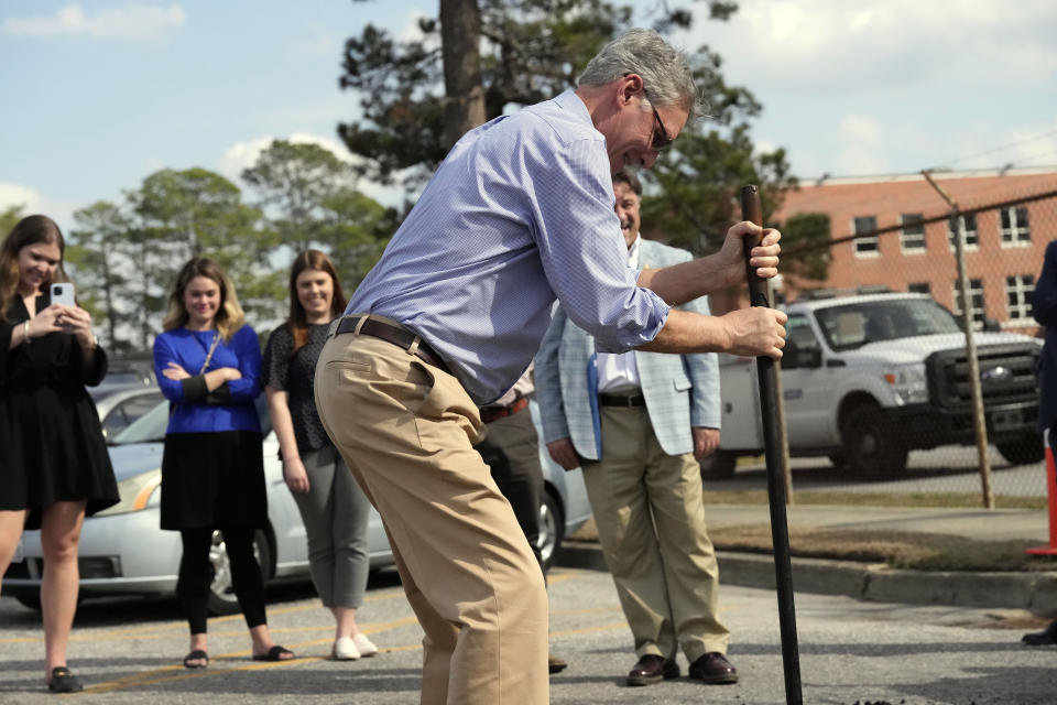 Rep. Tom Rice, R-S.C., helps fill in a pothole at a Department of Transportation facility in Florence, S.C., on Feb. 24, 2022. Rice is one of two South Carolina House Republicans facing spirited primary challenges this summer from rivals backed by former President Donald Trump that could signal the former president's grip on the party as he weighs another White House bid. (AP Photo/Meg Kinnard)