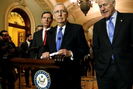 U.S. Senate Majority Leader Mitch McConnell (R-KY), flanked by Senator John Barrasso (R-WY) (L) and Senator John Cornyn (R-TX) (R), delivers remarks to reporters after their weekly party caucus luncheon at the U.S. Capitol in Washington, U.S., January 17, 2018.  REUTERS/Jonathan Ernst