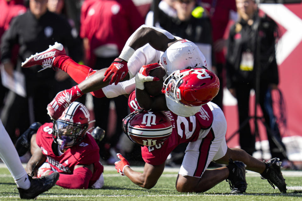 Rutgers running back Kyle Monangai (5) is tackled by Indiana defensive back Louis Moore (20) during the first half of an NCAA college football game in Bloomington, Ind., Saturday, Oct. 21, 2023. (AP Photo/Michael Conroy)