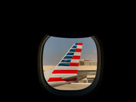 FILE PHOTO: An American Airlines airplane sits on the tarmac at LAX in Los Angeles, California, U.S., March 4, 2019. REUTERS/Lucy Nicholson/File Photo