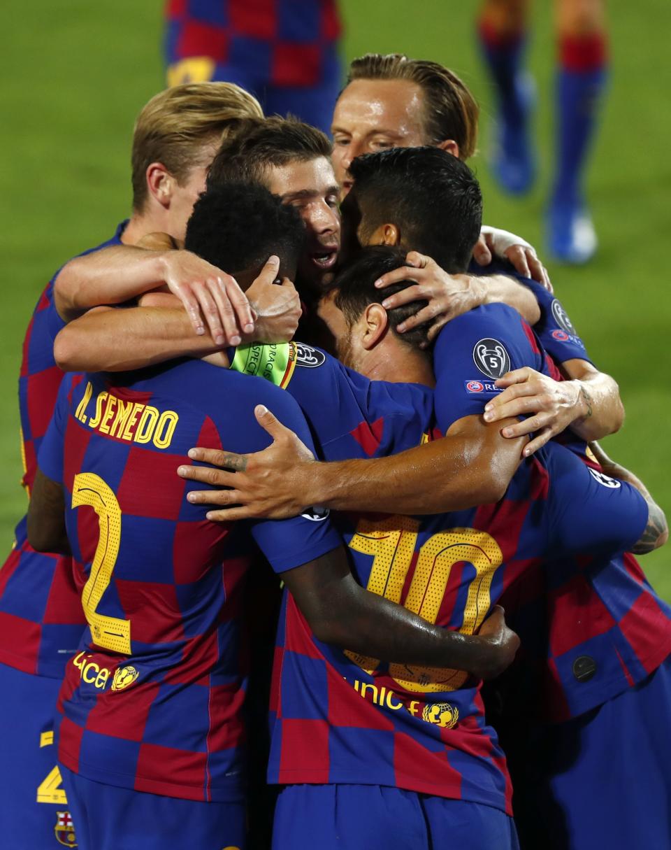 Barcelona's Lionel Messi celebrates with teammates after scoring his side's second goal during the Champions League round of 16, second leg soccer match between Barcelona and Napoli at the Camp Nou Stadium in Barcelona, Spain, Saturday, Aug. 8, 2020. (AP Photo/Joan Monfort)