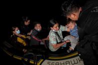 FILE PHOTO: Migrants seeking asylum cross the Rio Grande river in Roma