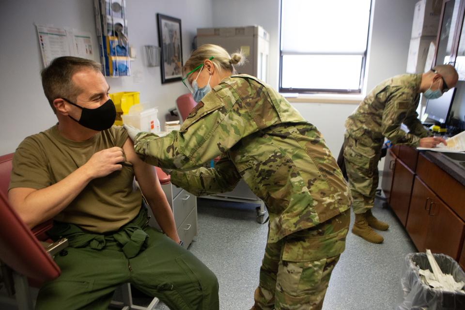 A Defend the Guard bill in the Kansas Statehouse could put federal funding and resources at risk. In February 2021, Kansas National Guard wing commander Dan Skoda receives the Moderna COVID-19 vaccine administered by 1st Lt. Jessica Miles while Capt. John Newcomer files paperwork in the background at the Air National Guard reserve at Forbes Air Force Base.