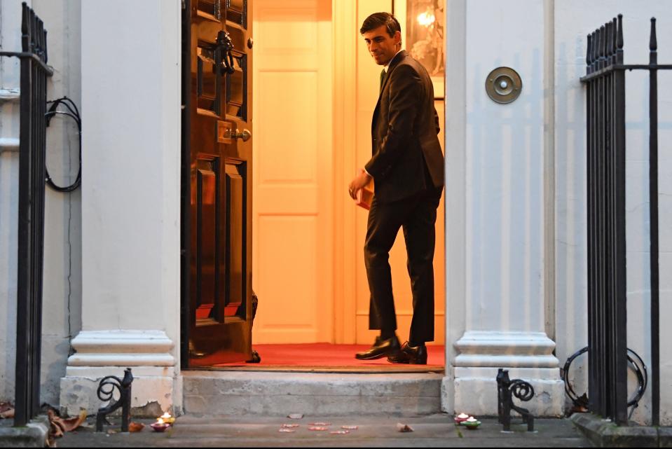 Chancellor Rishi Sunak lights candles outside 11 Downing Street for Diwali (PA)